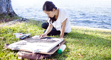 Community member painting at Lake Yosemite through a summer painting course.