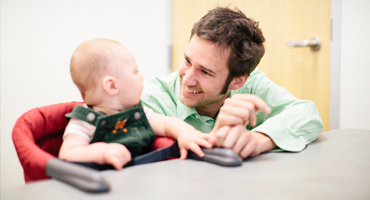 Professor  Walle works with child in lab.