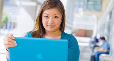 Student searching for courses on her Mac laptop.